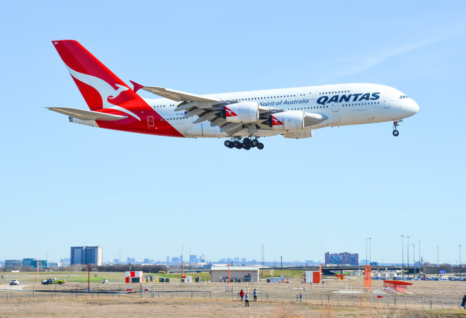 Qantas agrees to pay $79 million in compensation and a fine for selling seats on canceled flights
